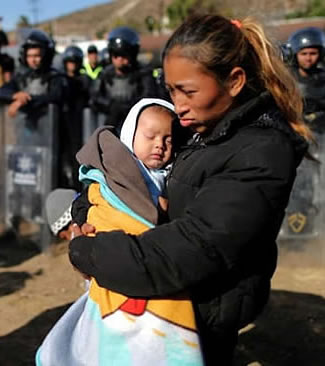 migrant caravan mother and child after being tear gassed by US military and border patrol