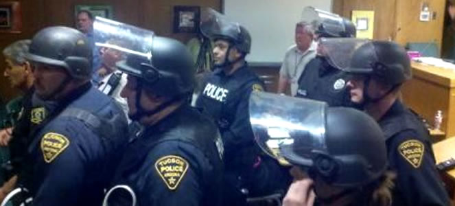 Tucson Police wearing riot gear swarm into a Tucson Unified School District (TUSD) Board meeting