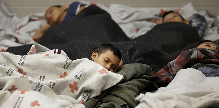 Immigrant Latino kids asleep on the floor at a U.S. Detention Center