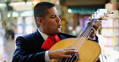 Maricahi singer with big guitar during Cinco de Mayo performance